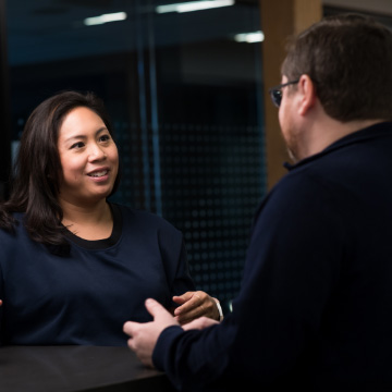 Vendors discussing a solution standing in the halls of their office